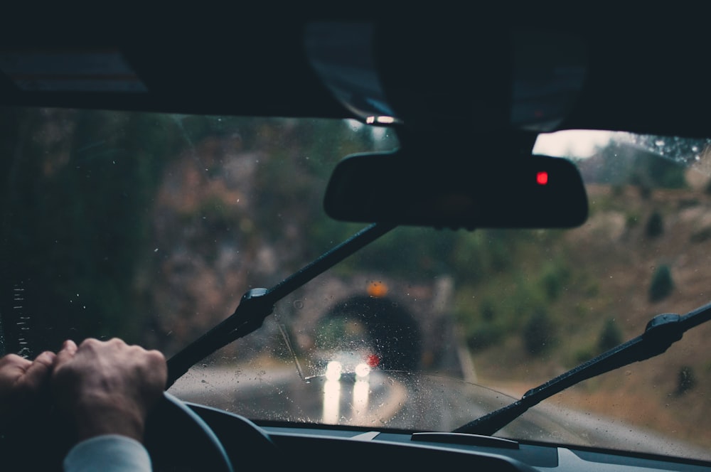 shallow focus photography of person driving