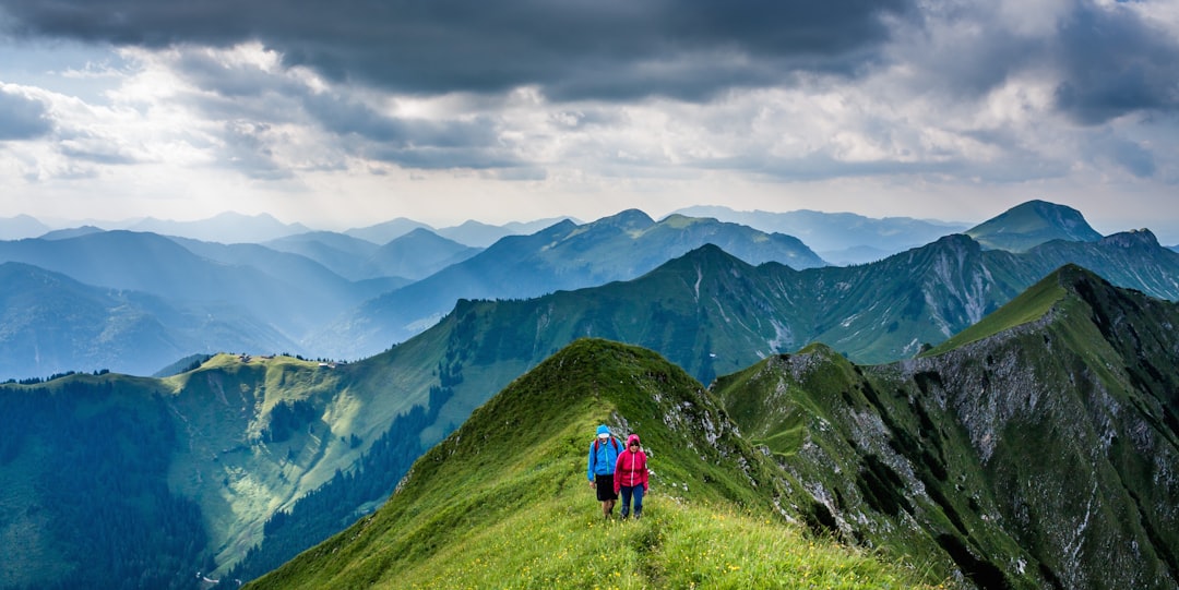 people walking on top of mountain, Hiking atop the grassy ridge