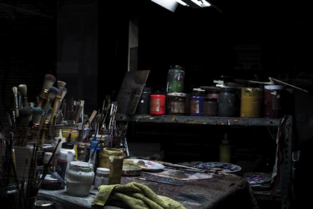 A cozy studio corner with paintbrushes and a colorful palette beside a painted pet portrait.