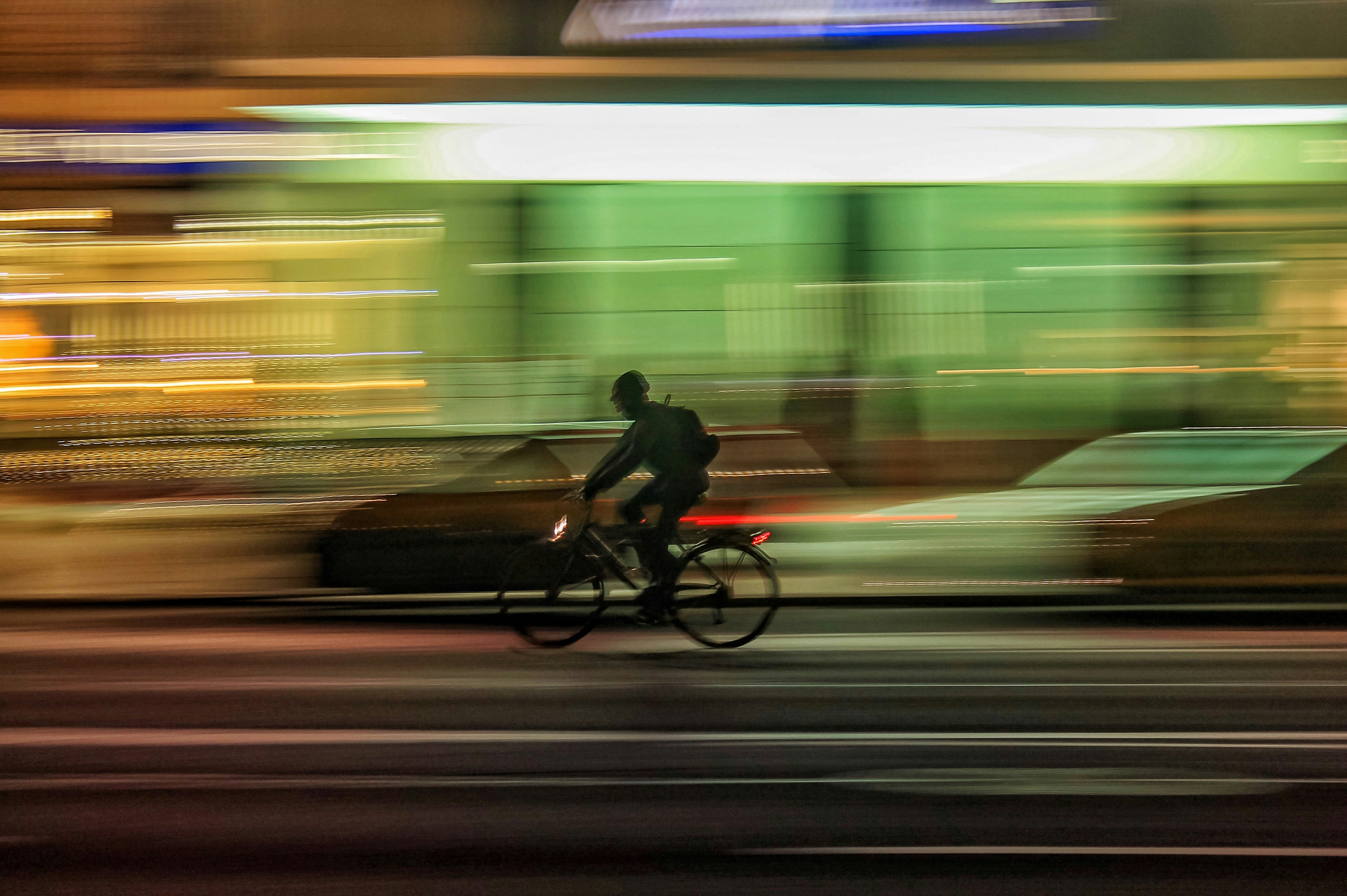 great photo recipe,how to photograph man on a bicycle at night; time lapse photo of person riding bicycle on road
