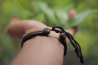 A model showcasing a bracelet in a natural outdoor setting.