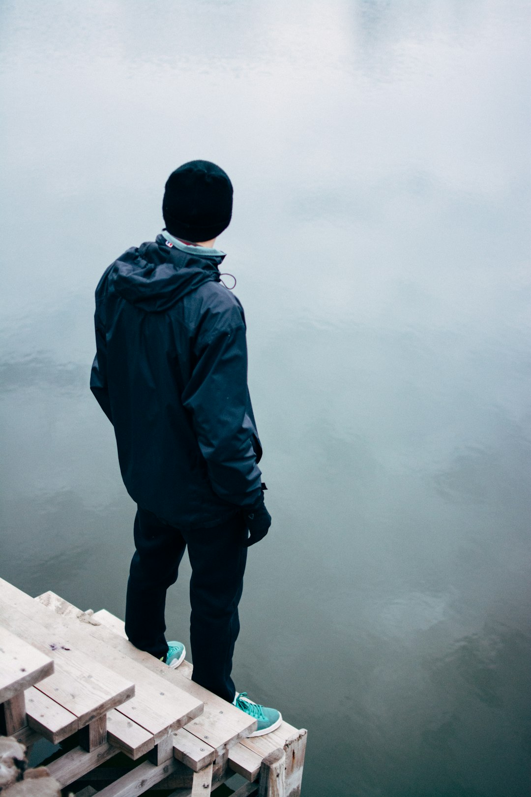 man standing on wooden stair