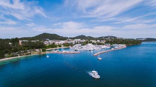 boat on calm body of water near island in Nelson Bay Australia