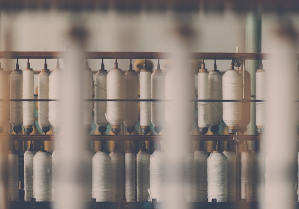 photography of white treadle on brown wooden rack