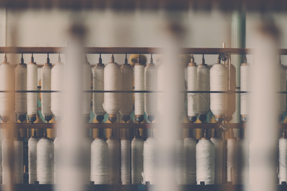 photography of white treadle on brown wooden rack