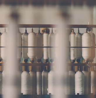 photography of white treadle on brown wooden rack