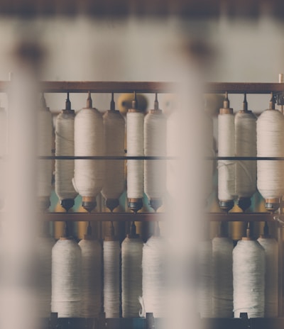 photography of white treadle on brown wooden rack