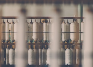 photography of white treadle on brown wooden rack