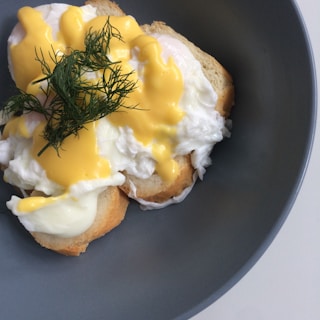 A plate of eggs benedict with perfectly poached eggs and hollandaise sauce.