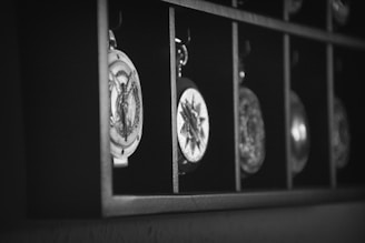 Hand-painted medallions arranged neatly on a table, highlighting the in-house artwork and personalized designs.