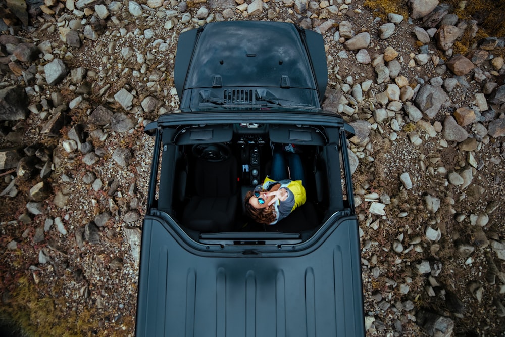 bird's eye view of person riding black top-down vehicle