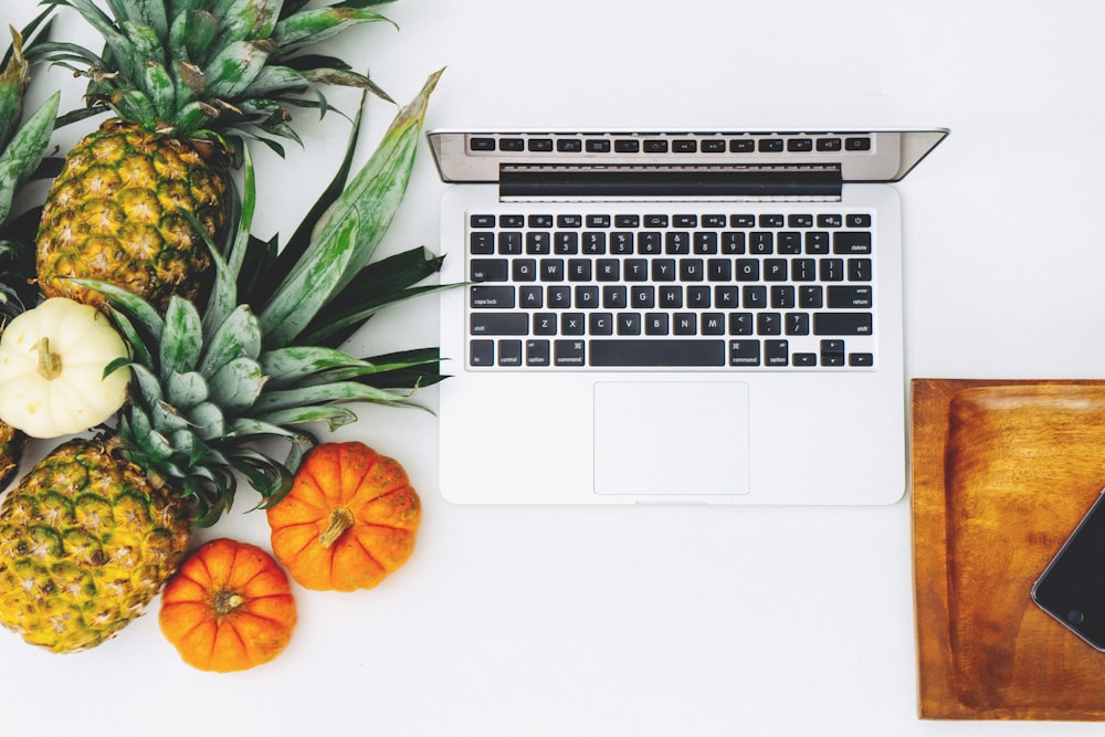 MacBook Pro and assorted fruits flat lay photography