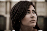 Close-up portrait of a person with expressive eyes against a blurred background.