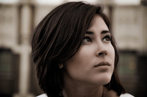 Close-up portrait of a person with expressive eyes against a blurred background.