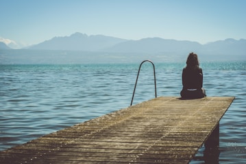 Person sitting alone looking down