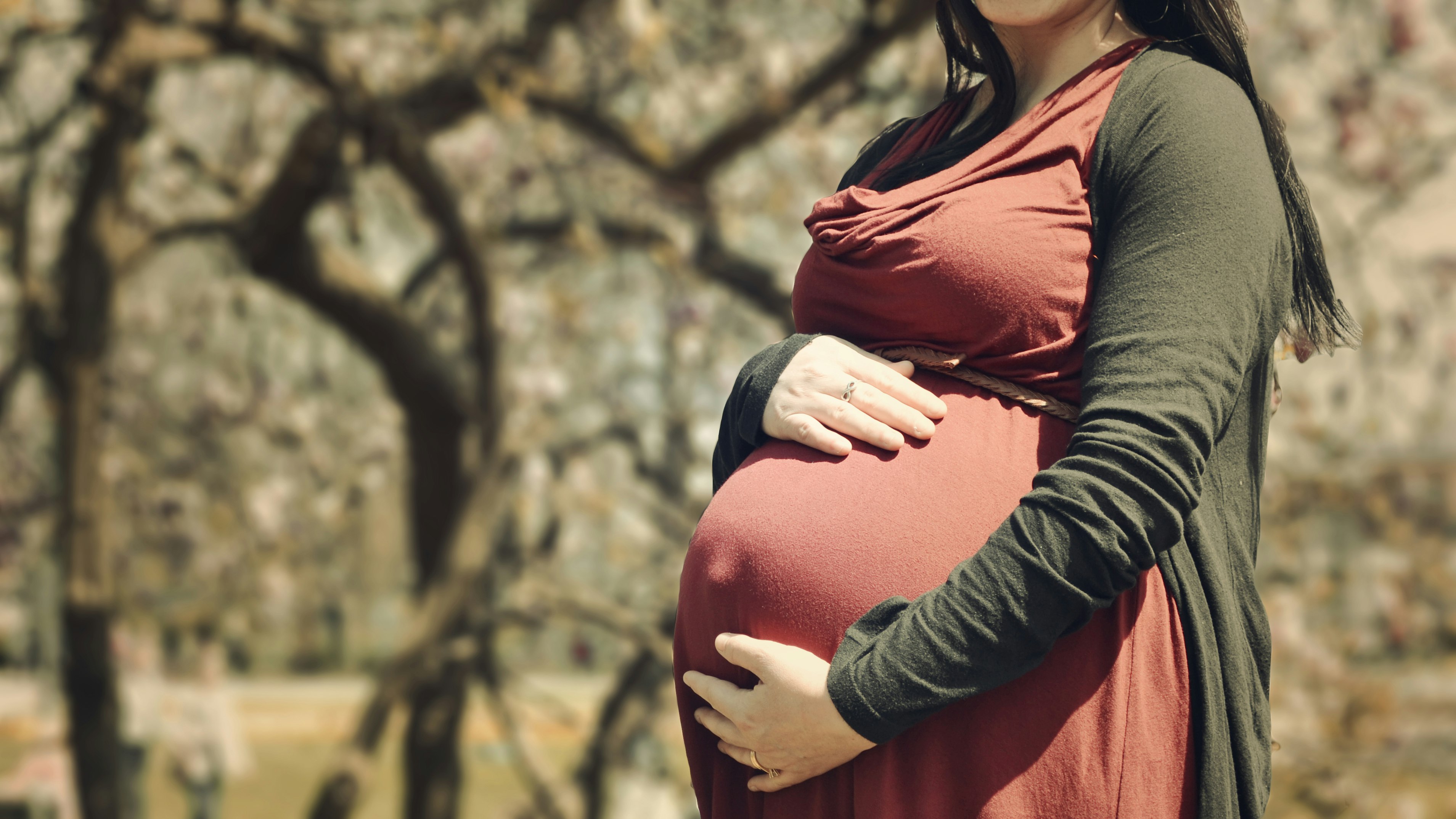 pregnant woman holding her stomach