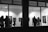 A diverse group of people admiring contemporary artworks in a bright gallery space.