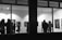 A diverse group of people admiring contemporary artworks in a bright gallery space.