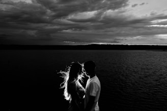 grayscale photo of couples near body of water