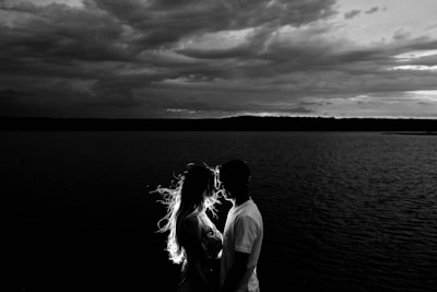 grayscale photo of couples near body of water