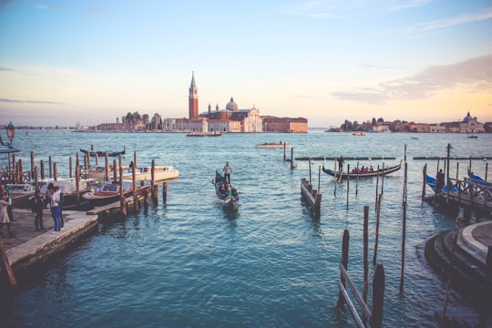 photography of of people near boat during daytime in Church of San Giorgio Maggiore Italy