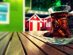 Close-up of a traditional Turkish tea set on a wooden table, steam rising gently.