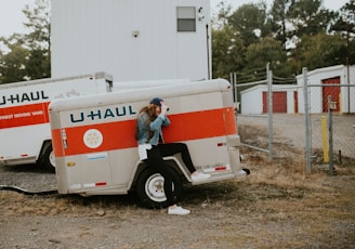 woman sitting on U-Haul trailer wheel fairings