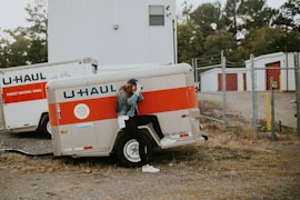 woman sitting on U-Haul trailer wheel fairings