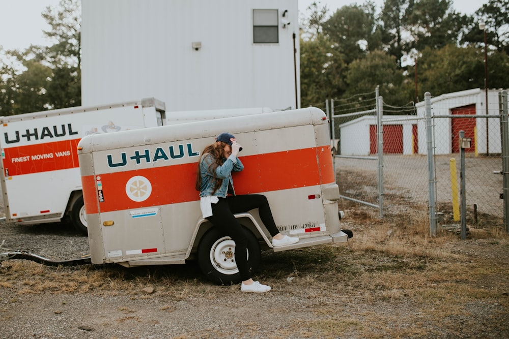 woman sitting on U-Haul trailer wheel fairings