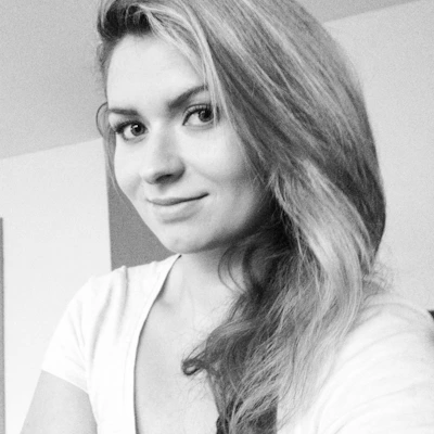 Portrait of Gražina, a professional lecturer, smiling confidently in a modern classroom setting