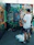 A street artist mid-creation, spray can in hand, adding vibrant details to a large wall piece.