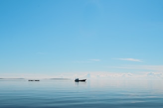 silhouette of boat on the ocean