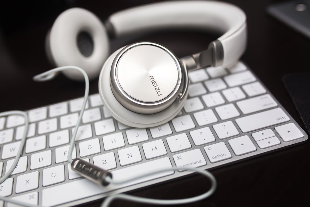 white Menzu corded headphones on Apple Magic keyboard