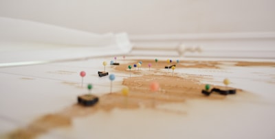 selective focus photography of pin map google meet background