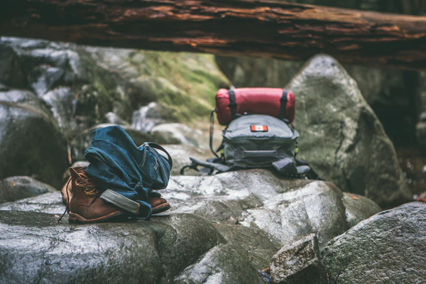 Backpacks on rocks during daytime