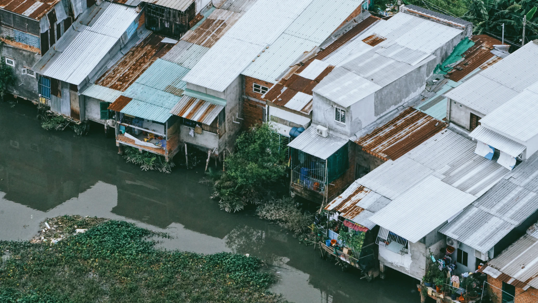 Stilt houses along a canal in Southeast Asia