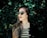 woman standing beside the hedge