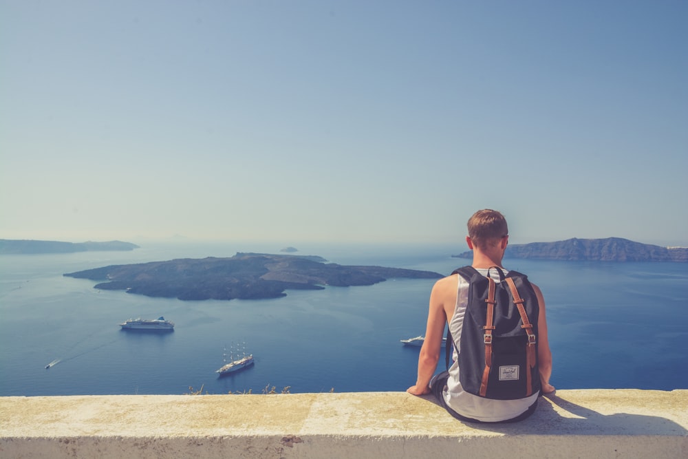 man sitting facing island