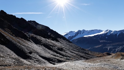 A CPR instructor demonstrating chest compressions on a training manikin in a bright classroom with mountain views.