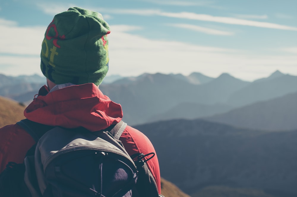 man standing on top of mountain