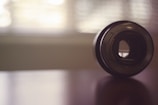 Minimalist composition of a camera lens reflecting soft white light