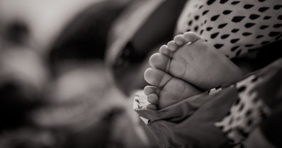 grayscale photo of baby's feet