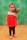A smiling young girl dressed in elegant children’s fashion from éclat jardin, standing near blooming flowers.