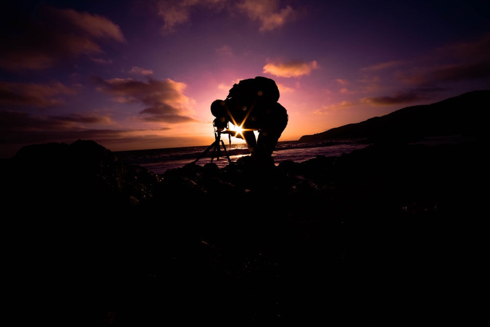 silhouette view of man bending under golden hour