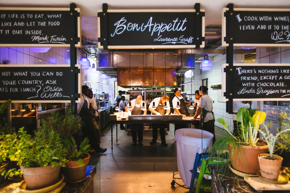 a group of people standing in front of a restaurant