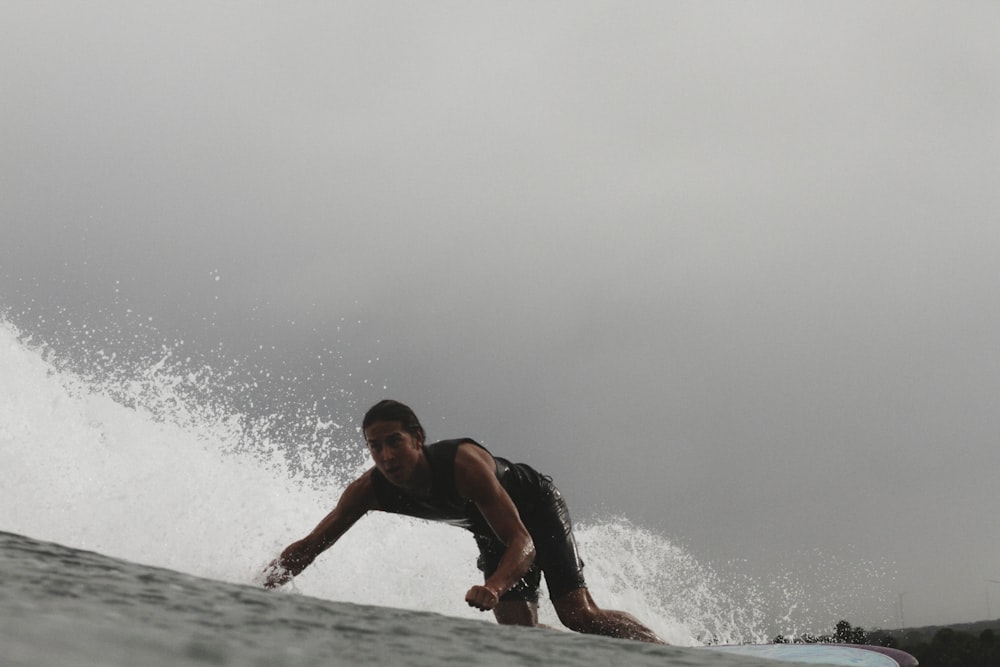 man surfing selective color photo