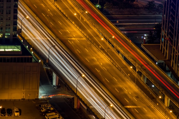 Wide shot of a highway at night with an Auto Socorro Brunao tow truck assisting a vehicle