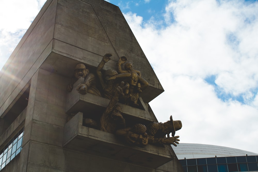 man mounted on wall statue