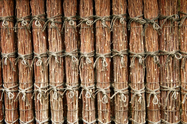 A bundle of strong, braided paper ropes arranged on a wooden surface