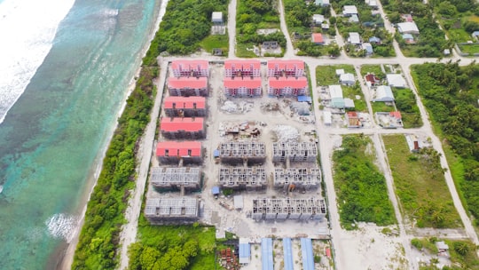 houses near green leafed trees during daytime in Addu City Maldives